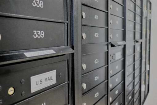 A row of black U.S. Mail mailboxes are lined up next to each other.