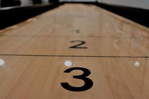 A wooden surface with the numbers 2 and 3 on it.