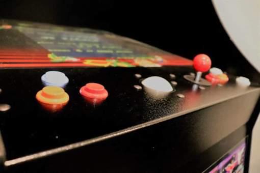 A close up of a pinball machine with a black background.
