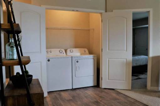 A small laundry room with a washer and dryer.