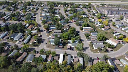 A bird's eye view of a residential area with houses and trees.