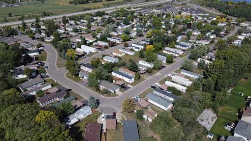 A bird's eye view of a residential area with houses and trees.