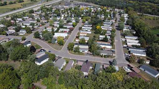 A bird's eye view of a residential area with houses and trees.