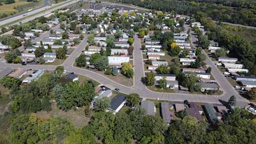 A bird's eye view of a residential area with houses and trees.