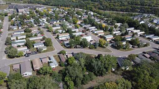 A bird's eye view of a residential area with houses and trees.