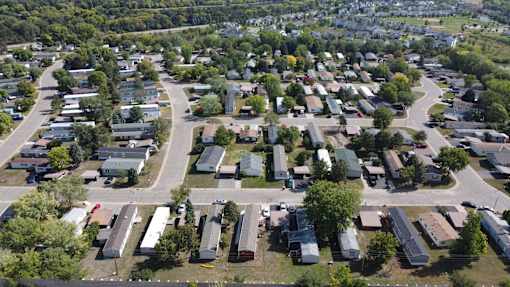 A bird's eye view of a residential area with houses and trees.