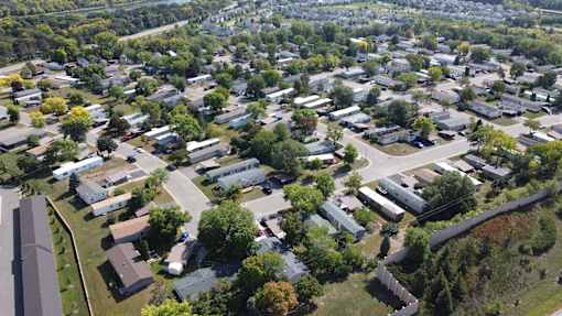 A bird's eye view of a residential area with houses and trees.