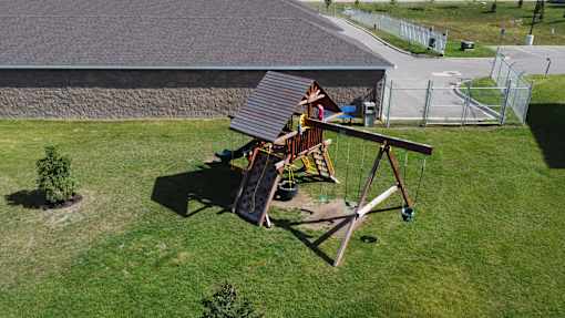 A swing set sits in a grassy yard.