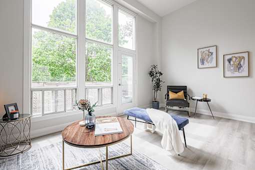 A living room with a blue chair and a coffee table.