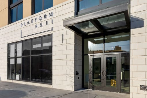 a brick building with a glass door and a sign that reads platform 466 at Platform 4611, Chicago