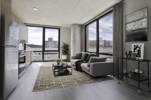 a living room with a couch and a coffee table in front of a window at Platform 4611, Chicago Illinois