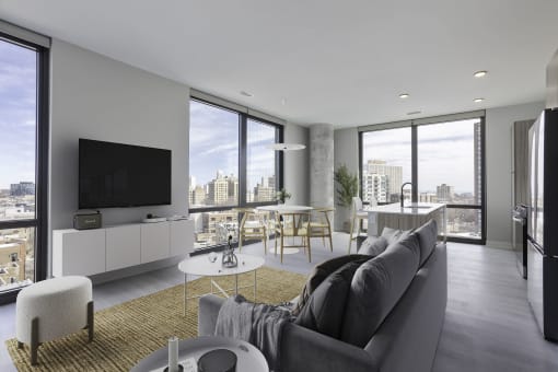 a living room with a gray couch and a yellow rug at Platform 4611, Chicago