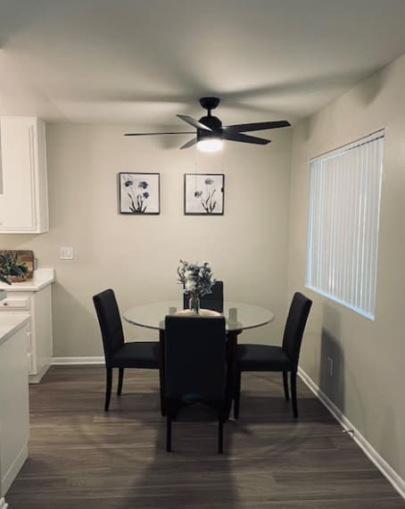 A dining room with a table set for two.