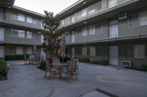 an outdoor patio area at the whispering winds apartments in pearland