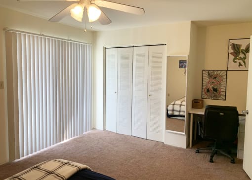 a bedroom with two closets and a desk