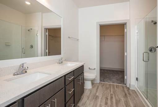 A bathroom with a sink, toilet, and shower.