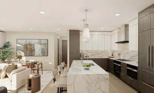 A modern kitchen with a marble countertop and a dining area with a white sofa and chairs.