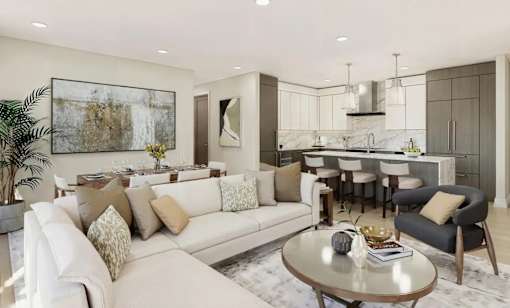 A modern living room with a white sofa, a coffee table, and a kitchen area in the background.