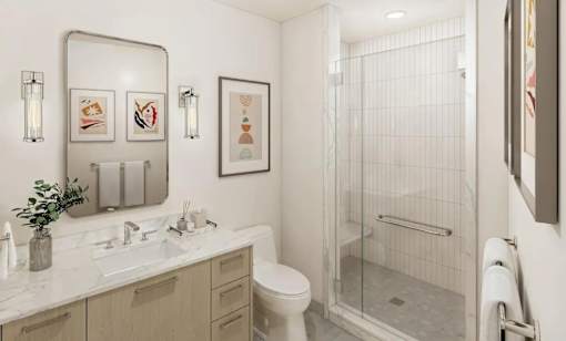 A bathroom with a toilet, sink, and shower.