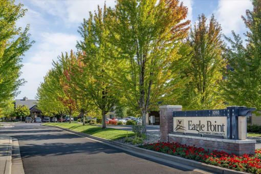 the entrance to eagle pointe in front of trees and flowers