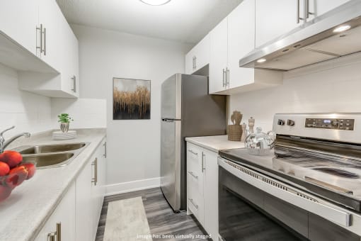 Kitchen with white cabinets and stainless steel appliances at Platts Crossing, Ontario, N6H 4P4