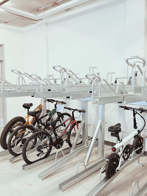 A bike rack with several bikes parked on it.