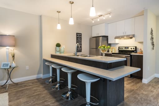a kitchen with an island and stools