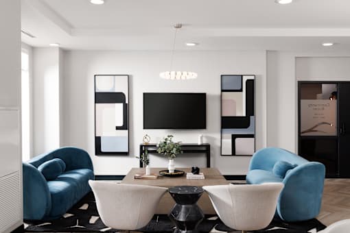 First floor Community Room with modern living room with a TV, two chairs, and a coffee table at 1600 Hyde Park Village Apartments, London