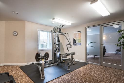 a fitness center with a treadmills and other exercise equipment