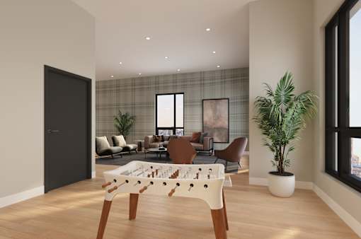 A modern living room with a foosball table in the center.
