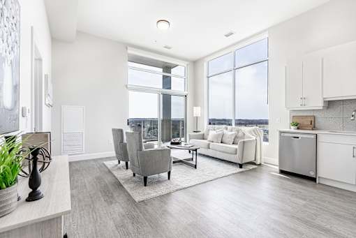 A modern living room with a large window and a view of the city.