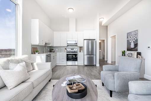 A modern kitchen with white cabinets and stainless steel appliances.