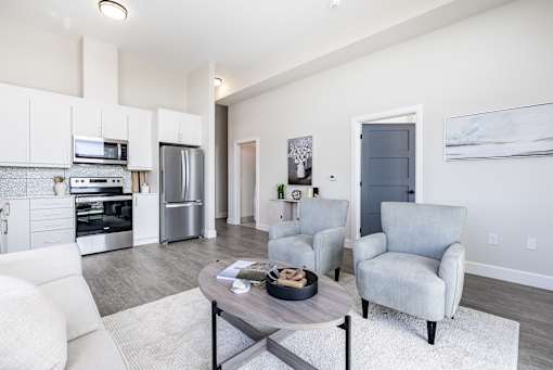 A modern kitchen with white cabinets and stainless steel appliances.