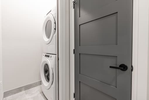 A washing machine is in a laundry room.