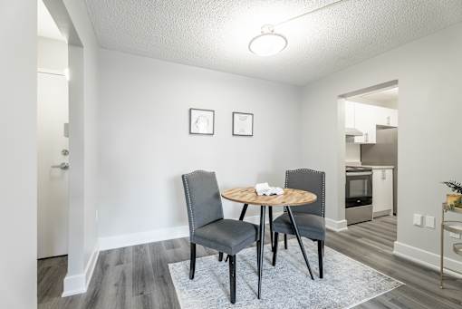 A dining room with a round table and chairs  at Platts Crossing, London, ON, N6H 4P4