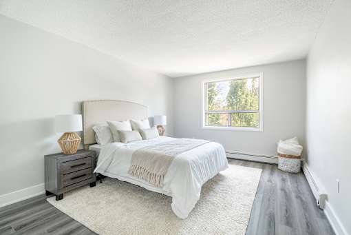 A bedroom with a large bed and a window  at Platts Crossing, London, ON, N6H 4P4