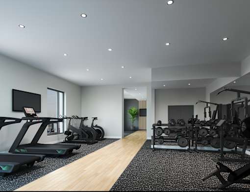 A spacious gym with treadmills, elliptical machines, and a weight room.
