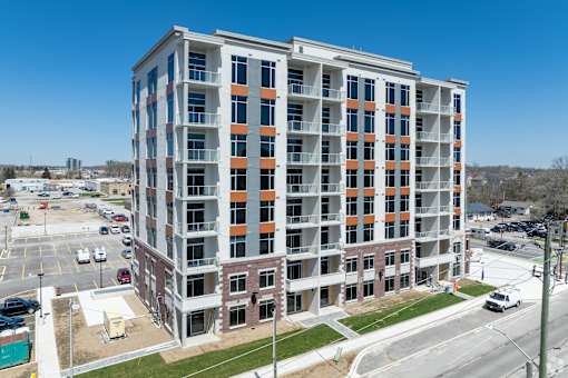 A large multi-story building with a parking lot in front.