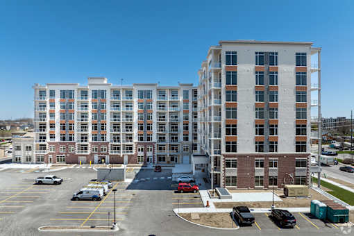 A large building with a parking lot in front of it.