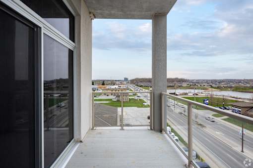 A view from a window looking out at a highway and a distant cityscape.