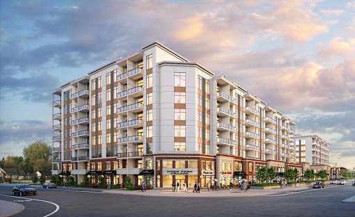 A large apartment building with a parking lot in front.