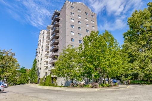 an empty street with an apartment building in the background