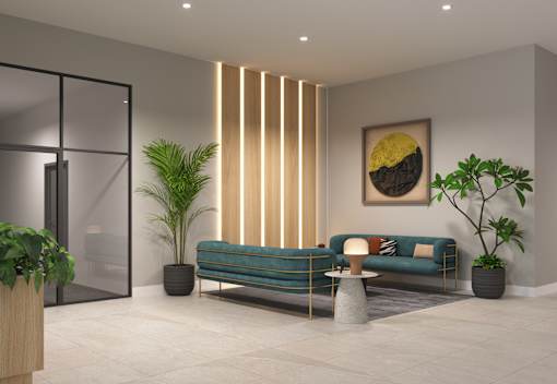 A modern living room with a blue sofa, a potted plant, and a framed picture on the wall.