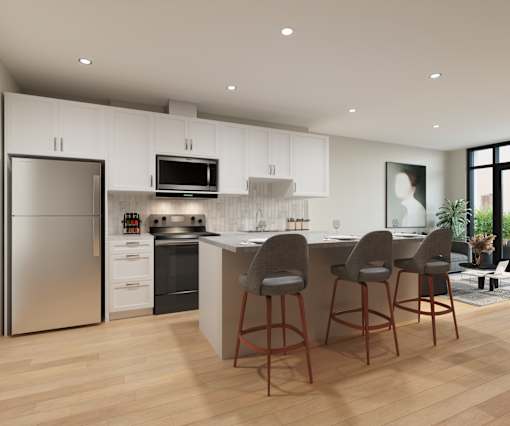 A modern kitchen with wooden floors and white cabinets.