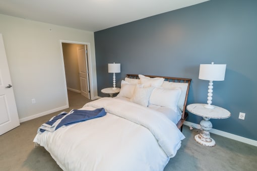a bedroom with a bed and two lamps
