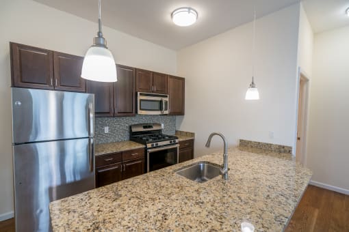 a kitchen with granite countertops and stainless steel appliances