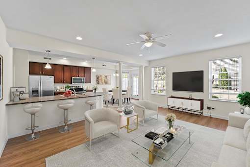 a living room with a kitchen and a couch and a table