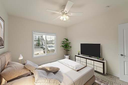 a bedroom with a large bed and a ceiling fan