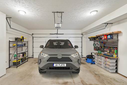 the car is parked in the garage of a home with a garage door open