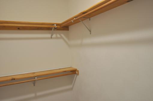 A wall with two shelves on it.